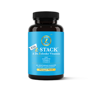 Bottle of Kids Z-Stack vitamins with blue label and black cap on white background